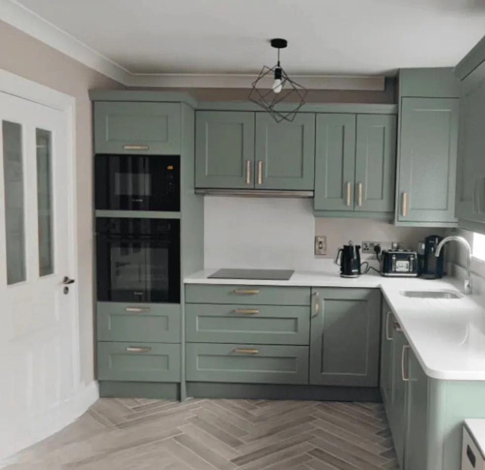 After: the example kitchen resprayed in sage green with brass handles (the real result)